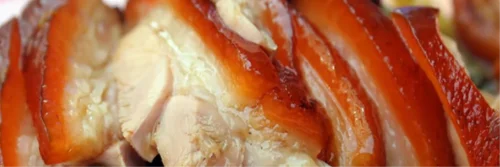 Spit roast hog being carved at an event in Devon